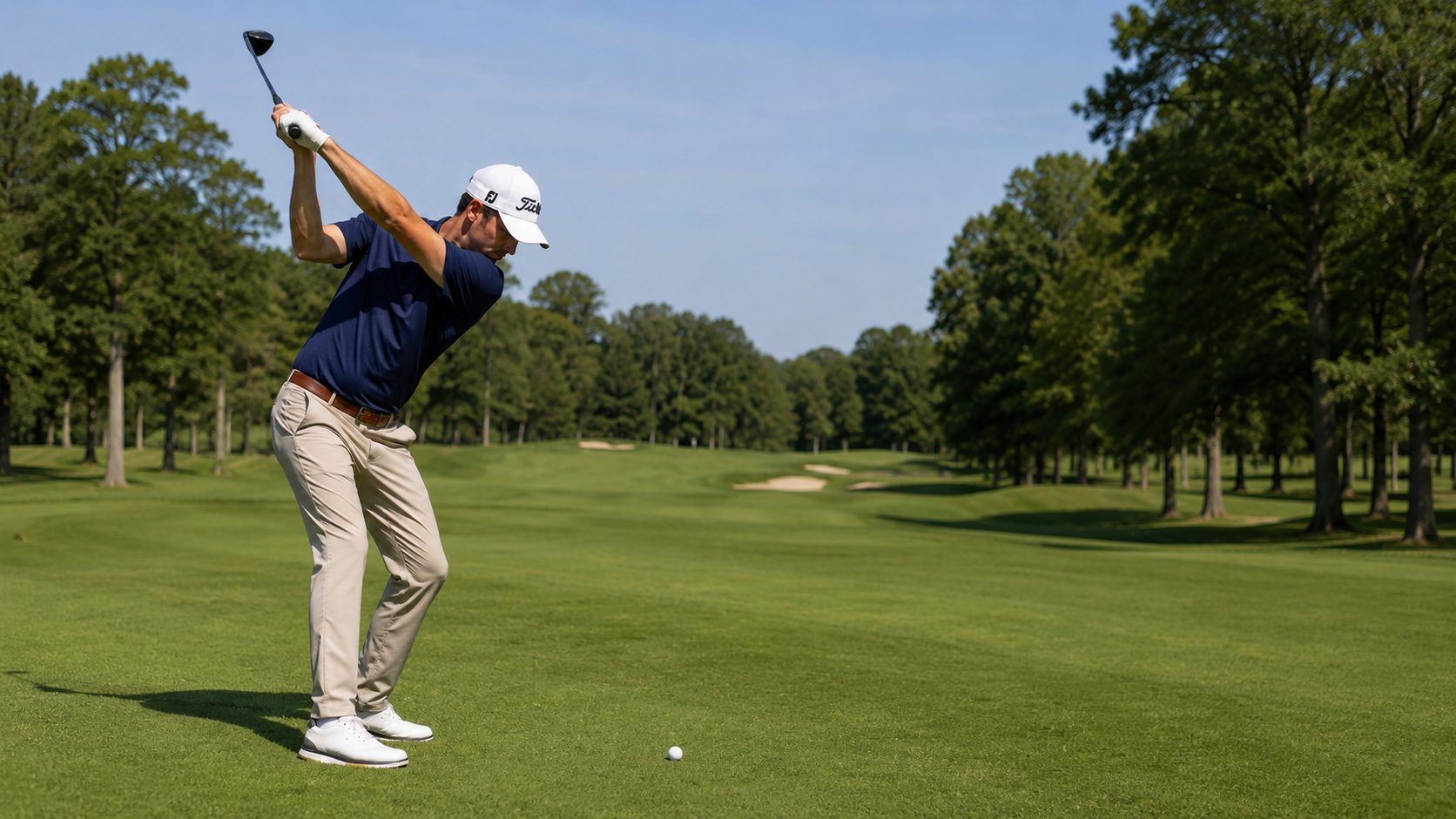 Golfer at the top of the backswing on the tee