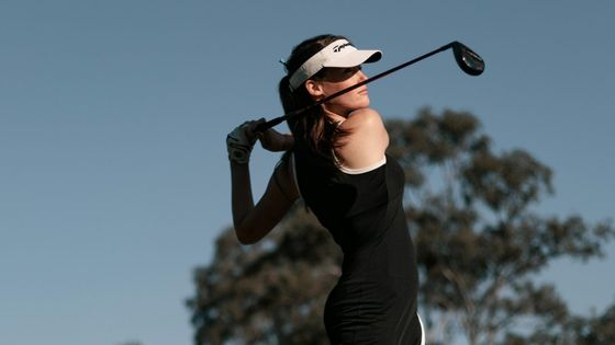 Woman golfer at the finish of a drive